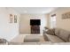 Spacious living room with a sectional sofa and an entertainment center at 12704 Leyden St # D, Thornton, CO 80602