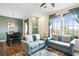 Bright, open-concept living space connected to the dining room with comfortable seating and large windows at 12704 Leyden St # D, Thornton, CO 80602