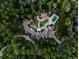 Stunning aerial view of estate featuring pool, lush landscaping, and winding driveway, showcasing the expansive property at 5 Mockingbird Ln, Cherry Hills Village, CO 80113
