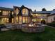 Backyard exterior featuring a stone fire pit and spacious patio; the perfect spot for outdoor entertaining at 5 Mockingbird Ln, Cherry Hills Village, CO 80113