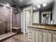 Bathroom featuring a glass shower with a seating area, granite counters and tile flooring at 5 Mockingbird Ln, Cherry Hills Village, CO 80113