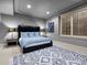 Charming bedroom featuring a black leather bed frame, blue bedding, and neutral gray walls at 5 Mockingbird Ln, Cherry Hills Village, CO 80113
