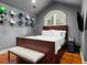 Bedroom features a leather headboard, wooden floors, and sports memorabilia on display at 5 Mockingbird Ln, Cherry Hills Village, CO 80113