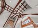 Unique ceiling design featuring exposed wooden beams and a stone accent wall at 5 Mockingbird Ln, Cherry Hills Village, CO 80113