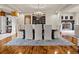 Formal dining room with large dining table, chandelier, fireplace, and view of the backyard at 5 Mockingbird Ln, Cherry Hills Village, CO 80113
