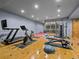 Home gym featuring wood flooring and a variety of exercise equipment, including a treadmill and bike at 5 Mockingbird Ln, Cherry Hills Village, CO 80113