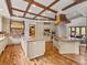 Spacious kitchen featuring wooden floors, an island, and granite countertops with a unique ceiling at 5 Mockingbird Ln, Cherry Hills Village, CO 80113