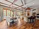 Gourmet kitchen with custom cabinetry, large center island, a dining table and hardwood flooring at 5 Mockingbird Ln, Cherry Hills Village, CO 80113