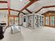 Spacious living room with exposed beams, a cozy sofa, and custom built-in shelving at 5 Mockingbird Ln, Cherry Hills Village, CO 80113