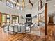 Elegant living room boasts hardwood floors, fireplace, staircase, and soaring ceilings with a stunning chandelier at 5 Mockingbird Ln, Cherry Hills Village, CO 80113