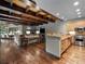 Open floor plan displays living room with stone fireplace adjacent to gourmet kitchen and breakfast bar at 5 Mockingbird Ln, Cherry Hills Village, CO 80113