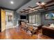 Living room featuring wood flooring, a TV, and stylish decor at 5 Mockingbird Ln, Cherry Hills Village, CO 80113