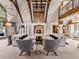 Inviting living room featuring a stone fireplace, vaulted ceiling, and natural light at 5 Mockingbird Ln, Cherry Hills Village, CO 80113
