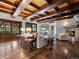 Bright living room features hardwood floors, beamed ceilings, stone fireplace, and ample natural light at 5 Mockingbird Ln, Cherry Hills Village, CO 80113