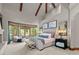 Spacious main bedroom with a fireplace, wooden beams and large windows for natural light at 5 Mockingbird Ln, Cherry Hills Village, CO 80113