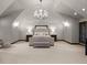 Spacious main bedroom suite features vaulted ceiling, carpet, chandelier, and abundant light at 5 Mockingbird Ln, Cherry Hills Village, CO 80113