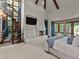 Elegant main bedroom with a fireplace, spiral staircase and large windows for natural light at 5 Mockingbird Ln, Cherry Hills Village, CO 80113