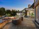 Back patio with an inviting stone fire pit and comfortable seating, perfect for outdoor entertaining at 5 Mockingbird Ln, Cherry Hills Village, CO 80113