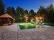 Backyard features large pool with lounge chairs, stone tile, gazebo, and mature trees at 5 Mockingbird Ln, Cherry Hills Village, CO 80113