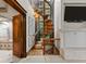 Unique spiral staircase and a stone fireplace at 5 Mockingbird Ln, Cherry Hills Village, CO 80113