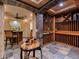 Custom wine cellar boasts stone accents, wood racks, and a tasting area for the wine enthusiast at 5 Mockingbird Ln, Cherry Hills Village, CO 80113
