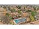 Community aerial view with a pool covered for the winter, set among green trees and well-maintained properties at 1981 S Hannibal Ct # B, Aurora, CO 80013