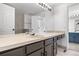 Bathroom with long vanity, sink, cabinets, and a large mirror for an open, airy feel at 1981 S Hannibal Ct # B, Aurora, CO 80013