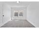 Neutral bedroom with two windows providing bright light, light colored carpet and white walls at 1981 S Hannibal Ct # B, Aurora, CO 80013