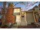 Charming home with red brick chimney, grey siding, and inviting front entry at 1981 S Hannibal Ct # B, Aurora, CO 80013