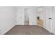 Hallway featuring white walls, neutral carpet and three doorways leading to other rooms at 1981 S Hannibal Ct # B, Aurora, CO 80013