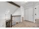 Hallway featuring carpet, white walls, and a staircase with dark railing leading to the main level at 1981 S Hannibal Ct # B, Aurora, CO 80013