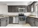 Bright kitchen with granite countertops, stainless steel appliances, and sleek cabinetry at 1981 S Hannibal Ct # B, Aurora, CO 80013