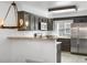 Stylish kitchen with stainless steel appliances, granite countertops, and modern lighting at 1981 S Hannibal Ct # B, Aurora, CO 80013