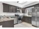 Well-lit kitchen features granite countertops, tile floor, and stainless steel appliances at 1981 S Hannibal Ct # B, Aurora, CO 80013