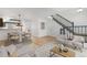 Bright living room with stylish furniture, hardwood floors, and staircase access at 1981 S Hannibal Ct # B, Aurora, CO 80013