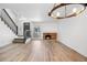 Inviting living room featuring hardwood floors, fireplace, and open staircase access at 1981 S Hannibal Ct # B, Aurora, CO 80013