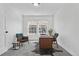 Bright office space with two windows, a gray area rug and a wooden desk, perfect for remote work at 1981 S Hannibal Ct # B, Aurora, CO 80013