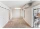 Bright bedroom featuring neutral carpeting, a window, closet space and a glass patio door leading to the outside at 1469 S Ulster St, Denver, CO 80231