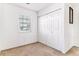 Spare bedroom featuring neutral walls, carpet, a window, and a closet at 1469 S Ulster St, Denver, CO 80231