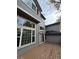 Back exterior view of a house with large windows looking out over a wooden deck at 1469 S Ulster St, Denver, CO 80231