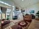 Open concept living room featuring fireplace and open staircase bathed in natural light at 1469 S Ulster St, Denver, CO 80231