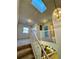 Bright stairwell with skylight featuring white railing at 1469 S Ulster St, Denver, CO 80231