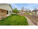 Nice lawn and beautiful landscaping featuring decorative rocks and a small stream at 3930 Miller St, Wheat Ridge, CO 80033