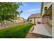 The backyard features a verdant lawn, rock accents, and private patio at 3930 Miller St, Wheat Ridge, CO 80033