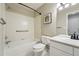 Bright white bathroom featuring a vanity, shower-tub combination, and neutral wall paint at 3930 Miller St, Wheat Ridge, CO 80033