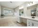 Bright bathroom with a soaking tub, double sinks, shiplap wall accents and neutral tile flooring at 3930 Miller St, Wheat Ridge, CO 80033