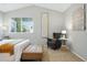 Bedroom sitting area with a gray chair and a white side table under a window with blinds at 3930 Miller St, Wheat Ridge, CO 80033