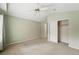 Bedroom with green walls, closet, and vaulted ceiling with fan. Neutral carpeting throughout at 3930 Miller St, Wheat Ridge, CO 80033