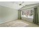 Bedroom with green walls, neutral carpeting, large window with curtains, and a vaulted ceiling with fan at 3930 Miller St, Wheat Ridge, CO 80033