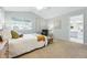 Bright bedroom featuring neutral walls, vaulted ceiling, ensuite bathroom, and stylish decor at 3930 Miller St, Wheat Ridge, CO 80033